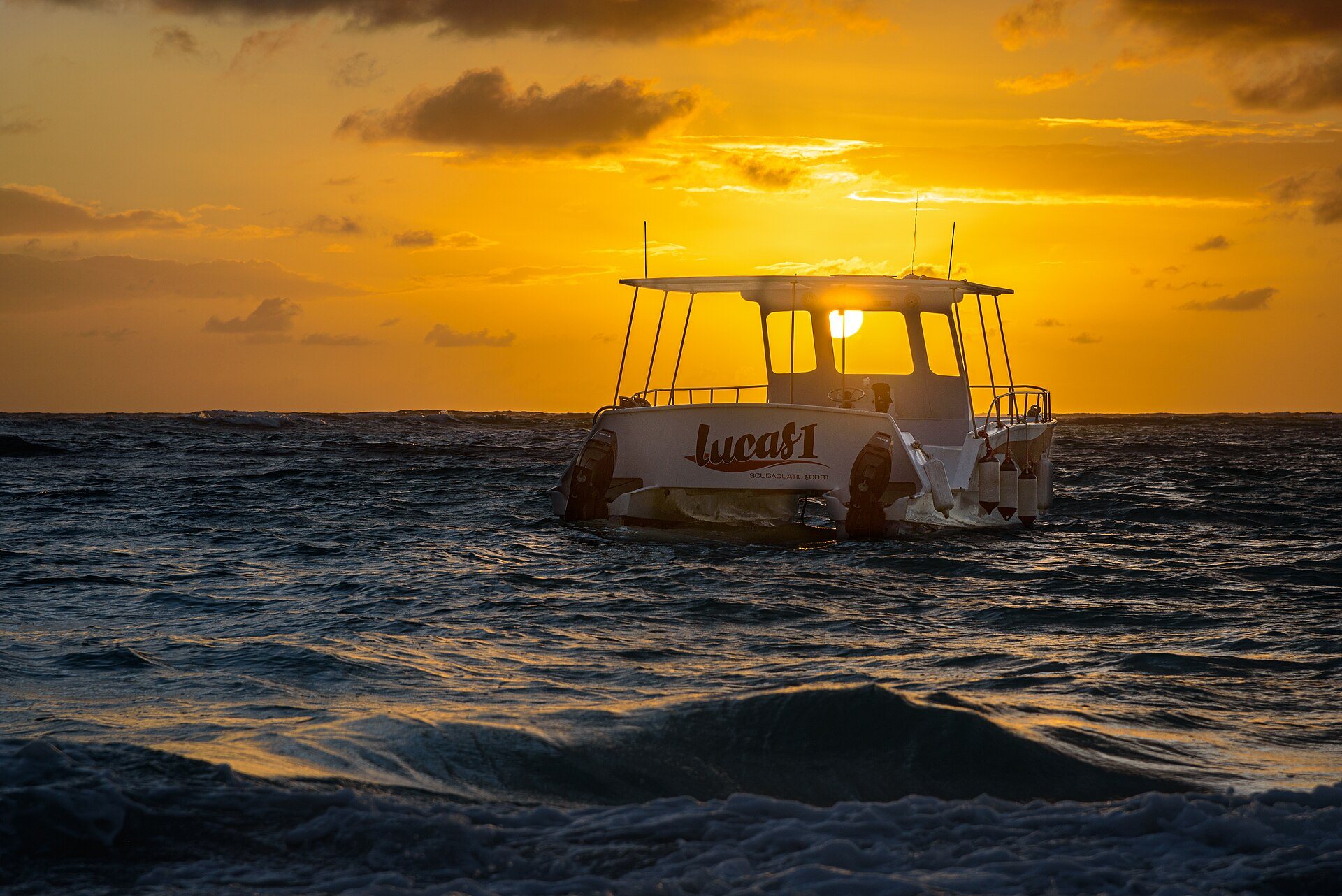Catamaran cruising off the Dominican coast at sunset